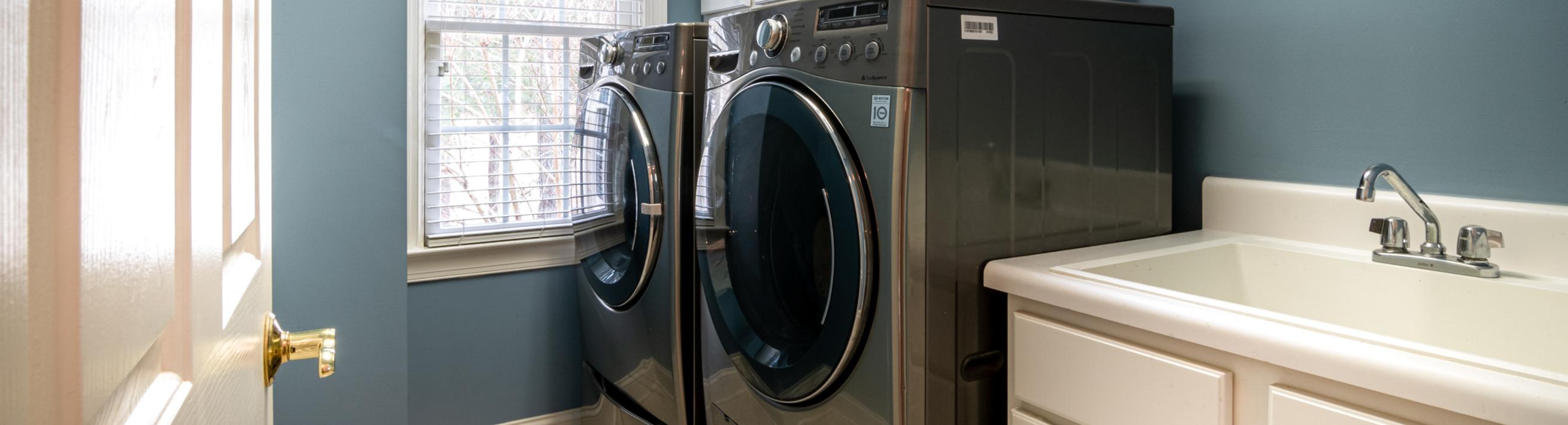 A washing machine and clothes dryer in a laundry room