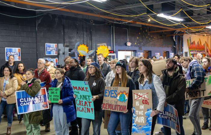 Row of people holding signs at Climate Rally in 2025