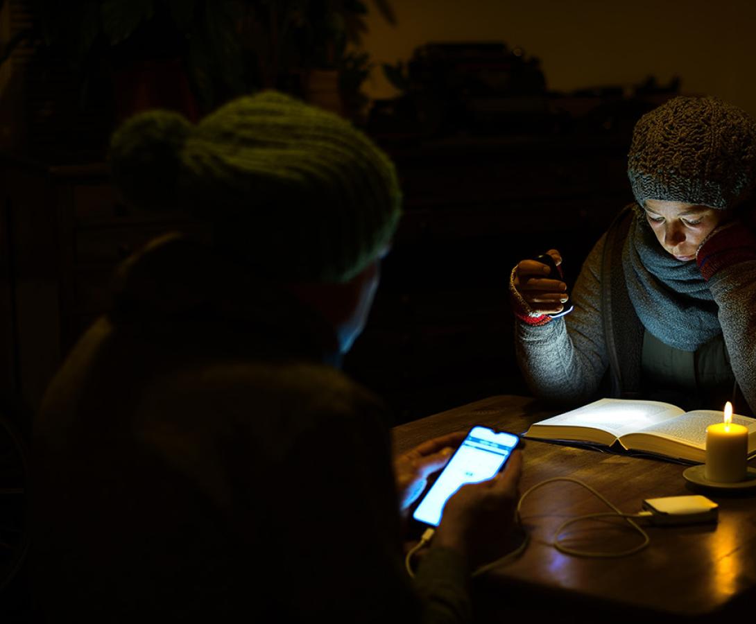 People sitting in the dark because the power is out