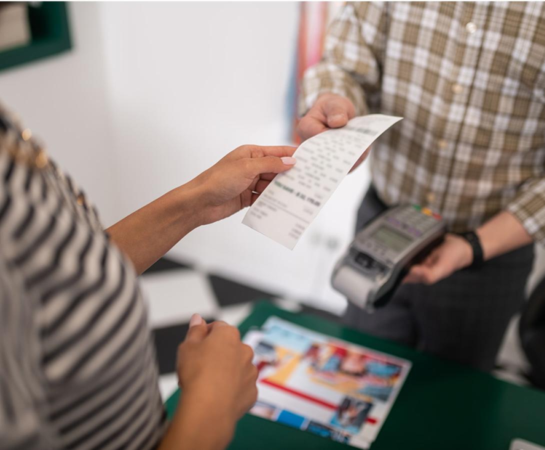 people handling receipt paper