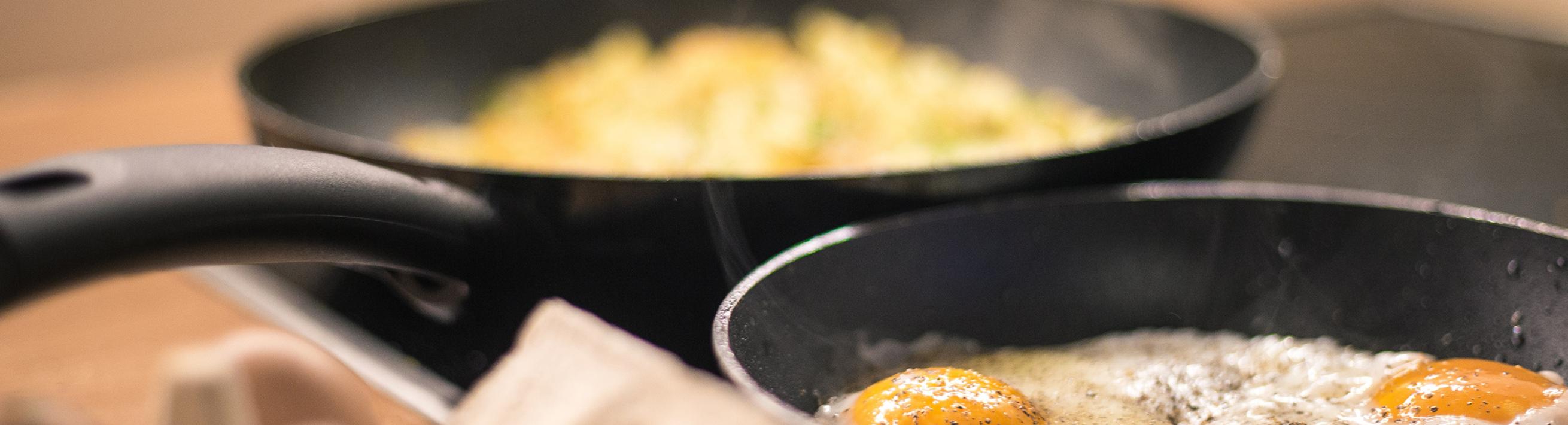 Eggs cooking in frying pans