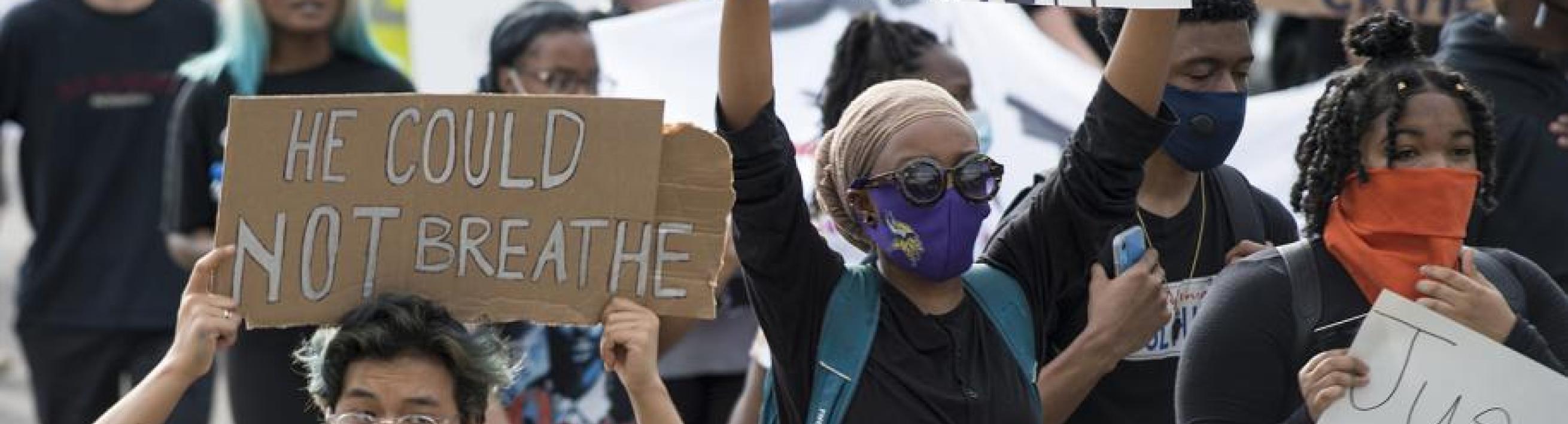 People march during a protest opposing police violence