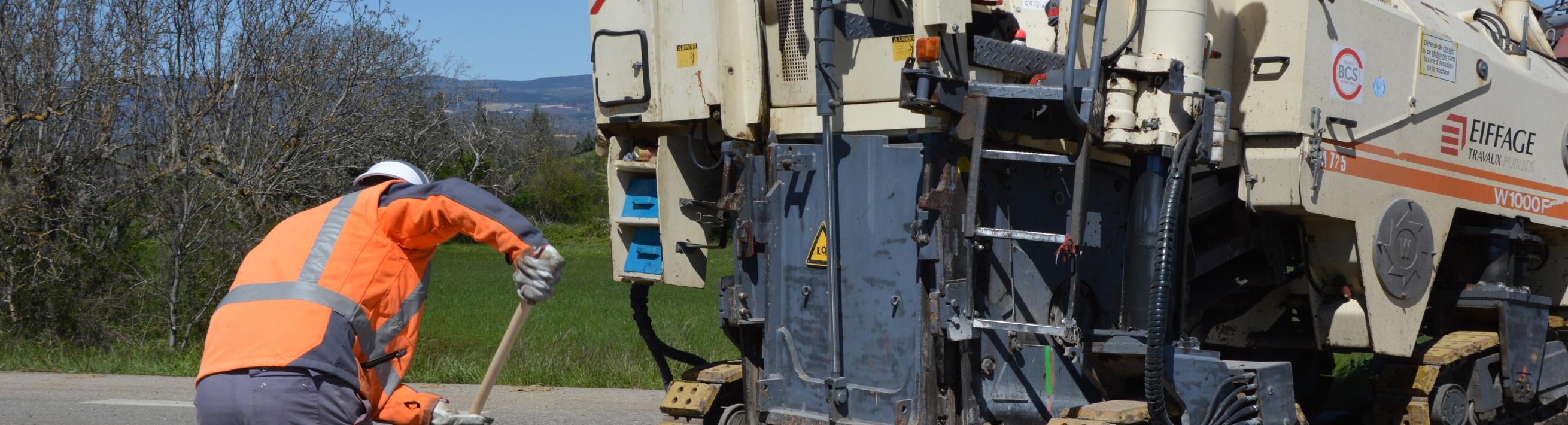 Workers using coal tar sealants on a road