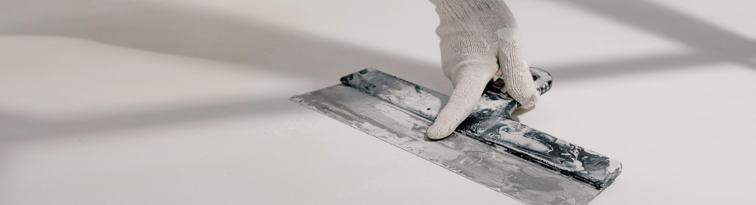 Drywall being smoothed out with a tool