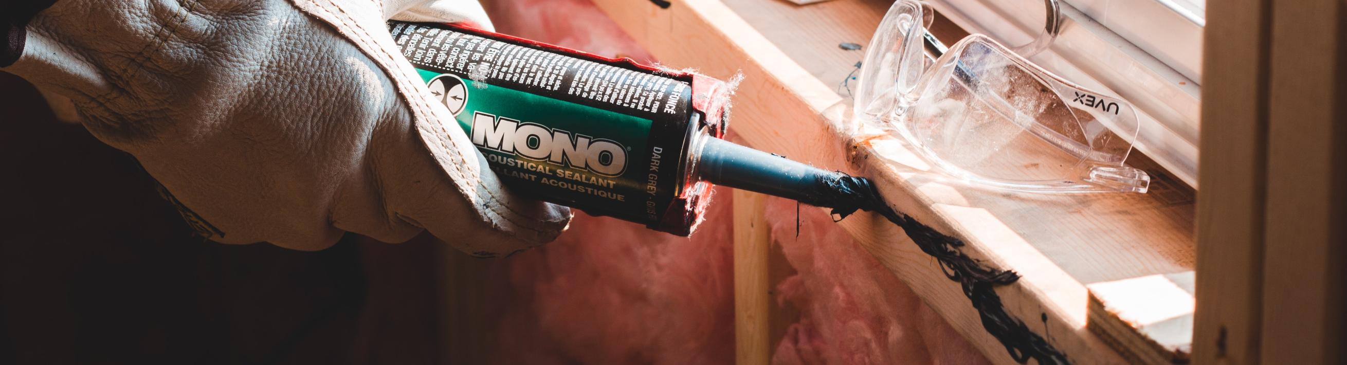 Sealant being applied along a window sill