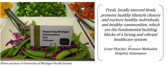 Nestled in a bed of snap peas and red cabbage is a card that reads, "Supporting Michigan Communities / Red Cabbage"
