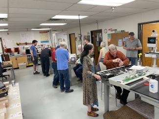 Photo of everyone working on different repairs at the Fix It Friday event